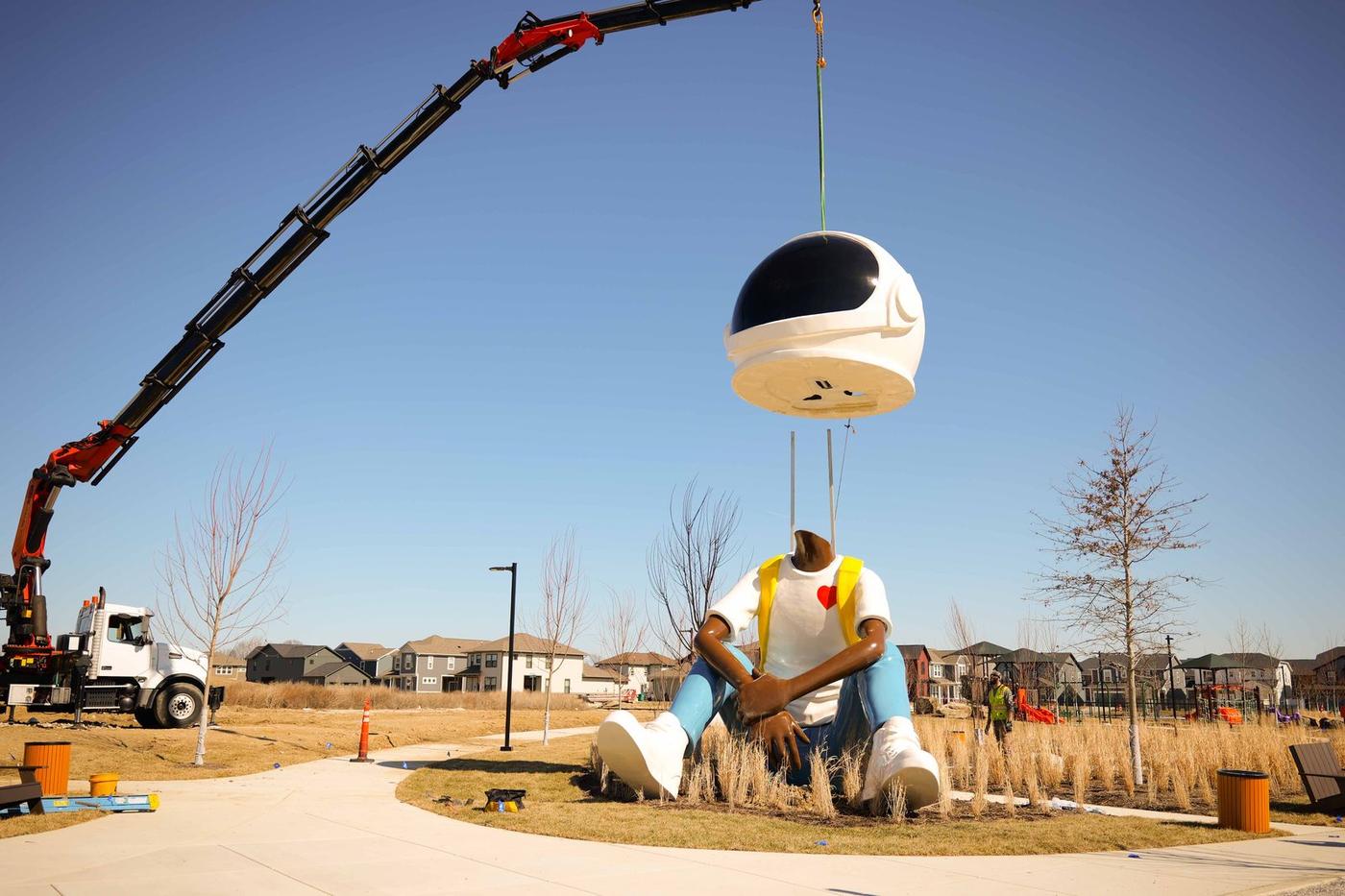 25-foot Aku Dreamgazer sculpture being craned into place at Hobbs Station, Plainfield